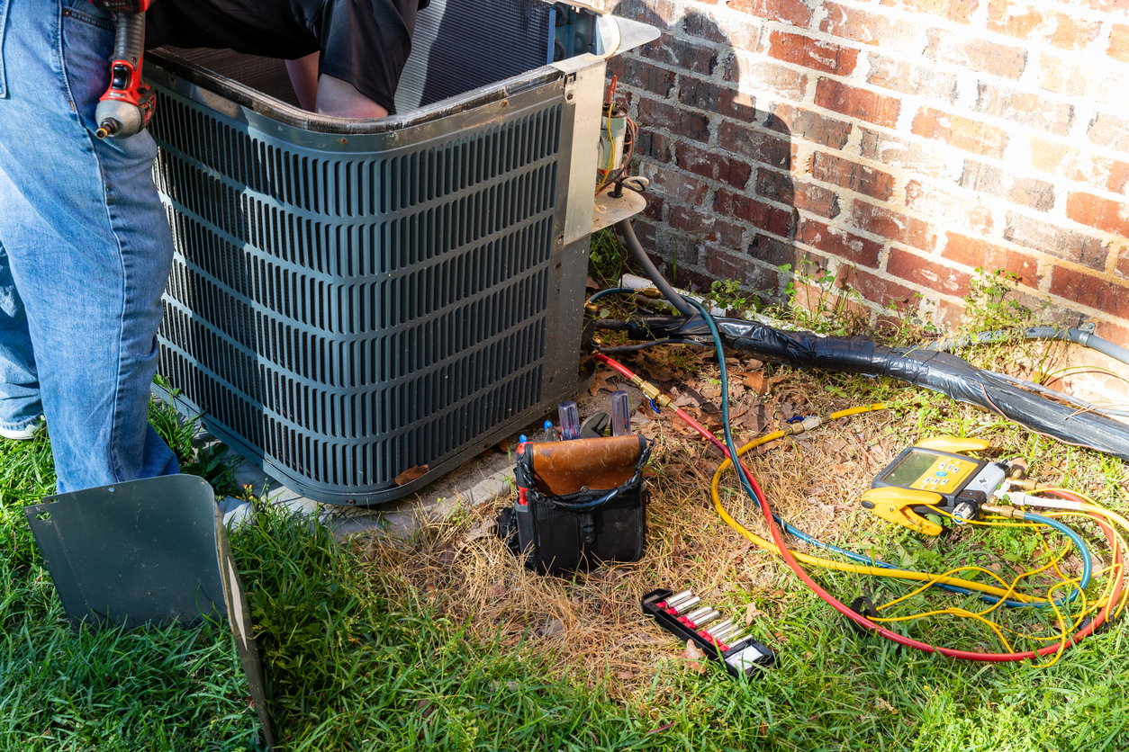 Technician performing a service on a residential HVAC system