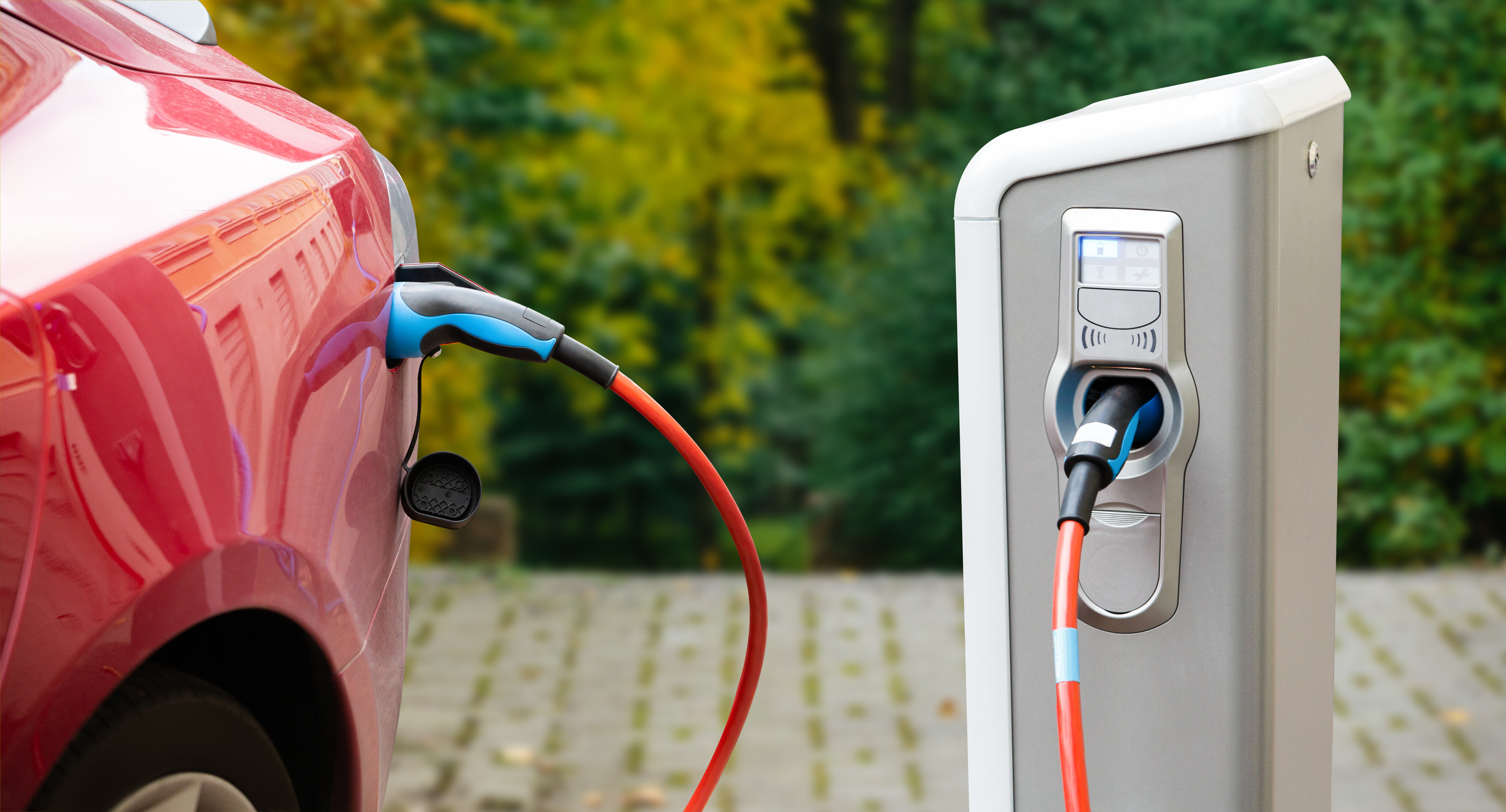 car being charged by an electric vehicle charger in Southeast Michigan