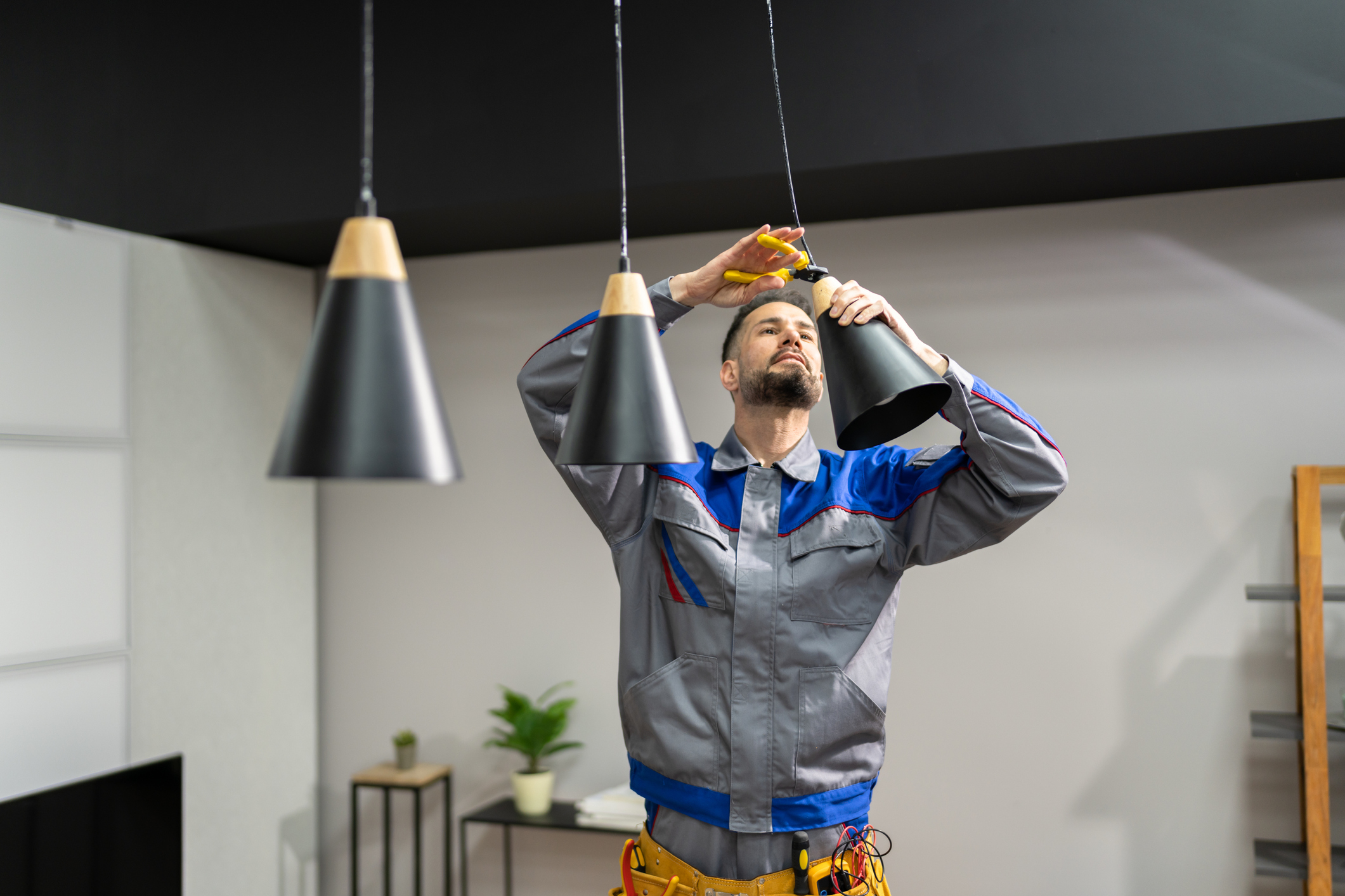 Electrician replacing pendant lighting in a residence 