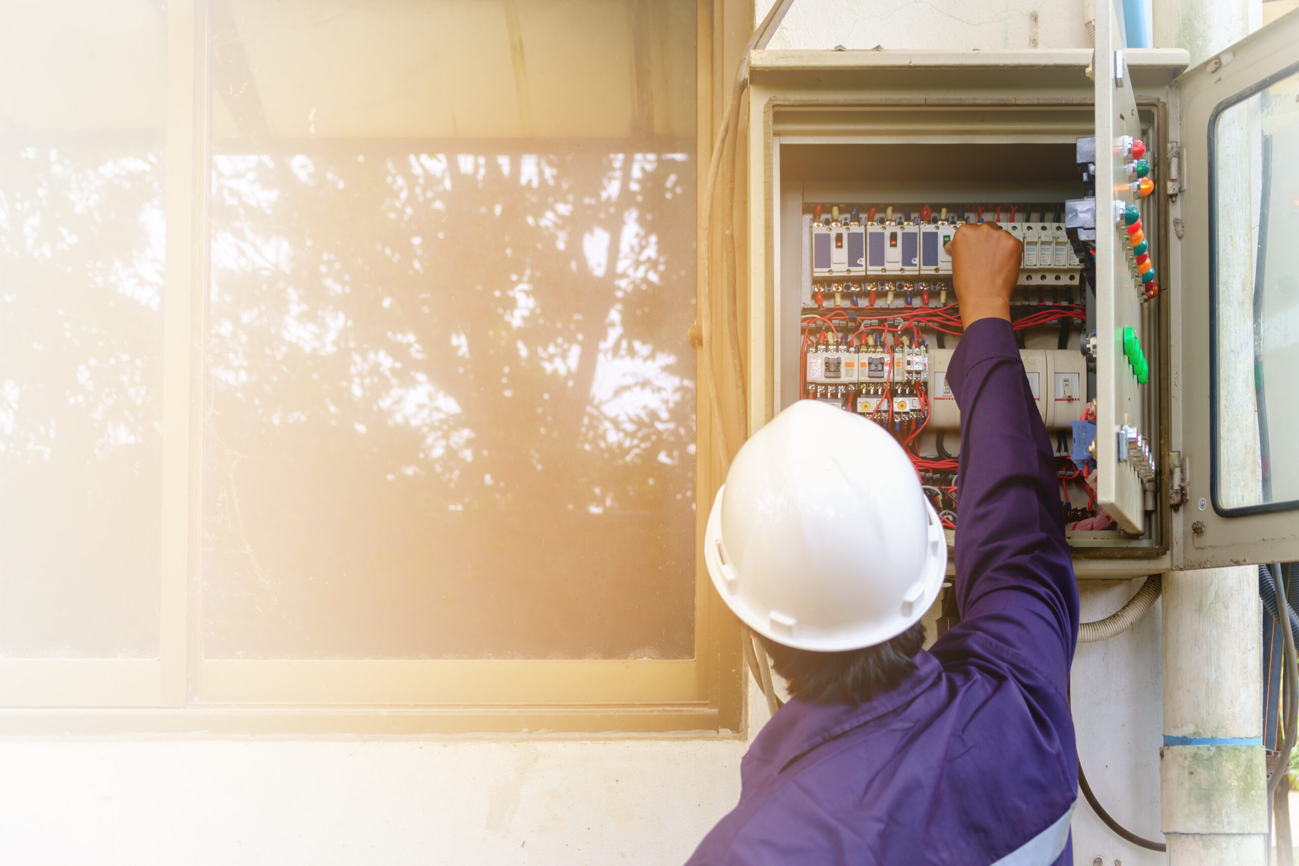 Electrician working on a home's electrical panel 
