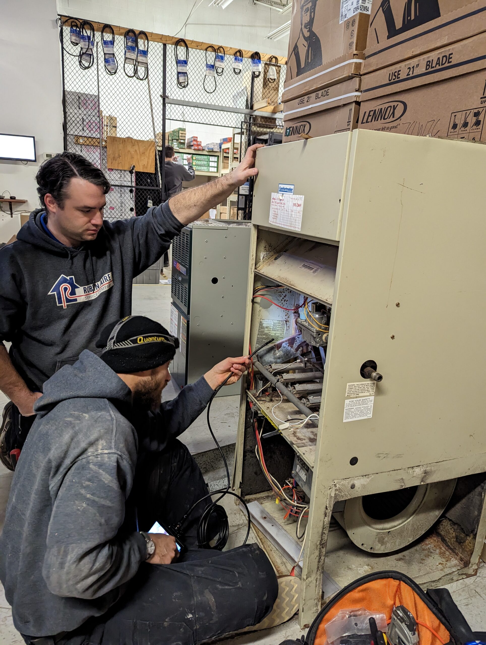 HVAC technician working on a residential gas furnace
