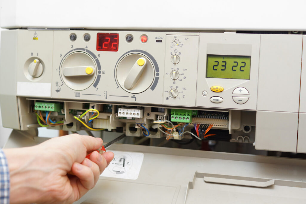 HVAC technician adjusting a home furnace