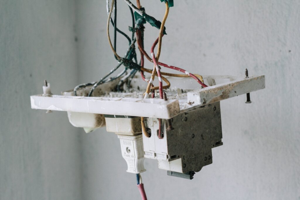 Entire outlet fell out of the wall, hanging on by wires