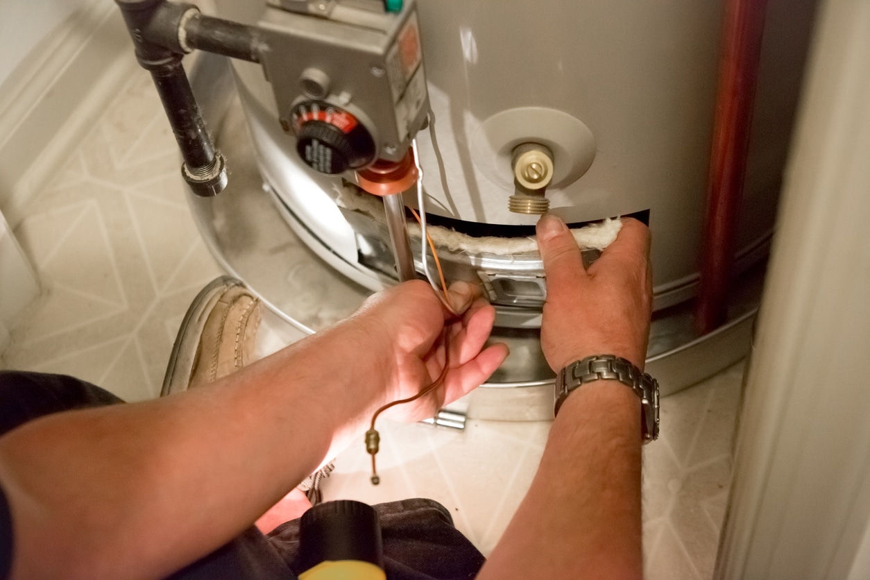 Plumber performing water heater tune up