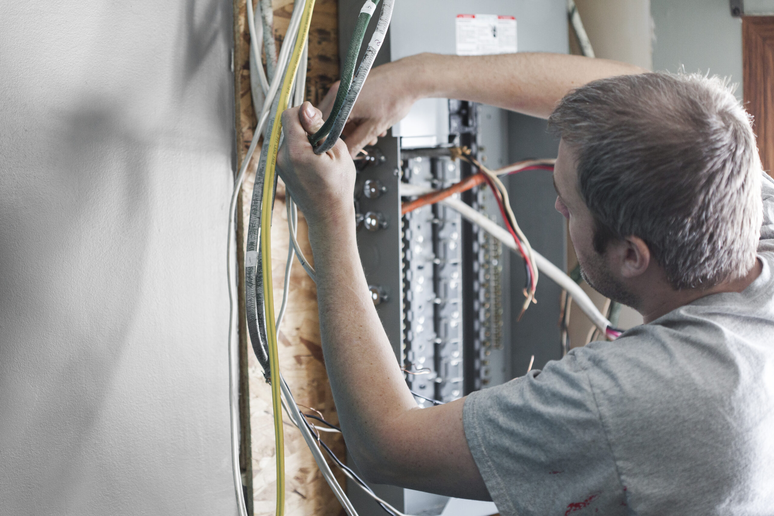 Electrician working on residential electrical panel