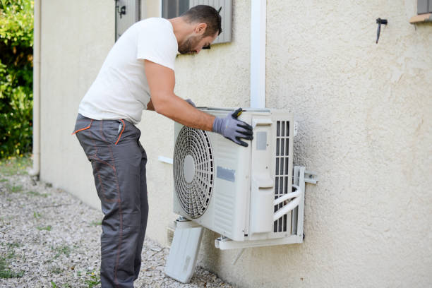 HVAC technician installing new heat pump